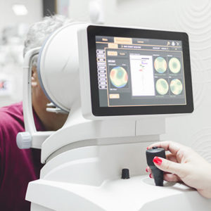 Retina scanning machinery in use on patient