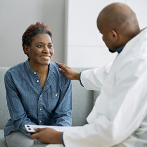 Consultant speaking to and assuring a woman patient
