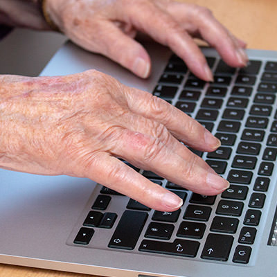 Older patient using a laptop computer