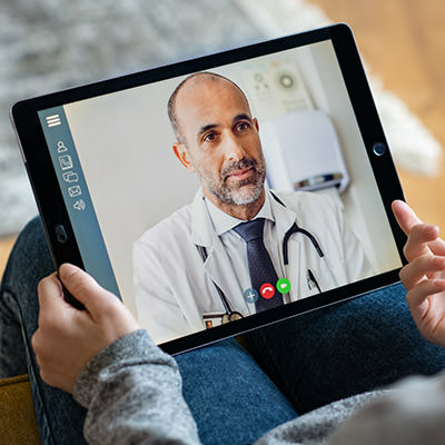 Patient on a video call with a male consultant